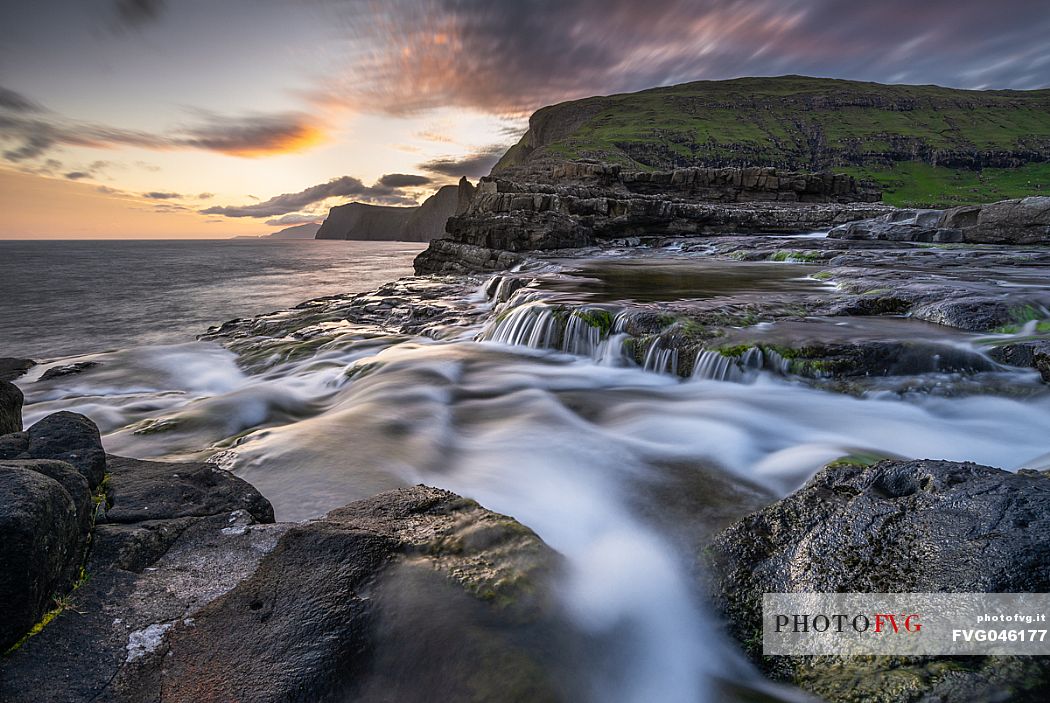 The Bsdalafossur waterfall flows from the Leitisvatn lake on the island of Vagar. This waterfall, like many others in the archipelago, falls directly into the Atlantic ocean., Faeroe islands, Denmark, Europe